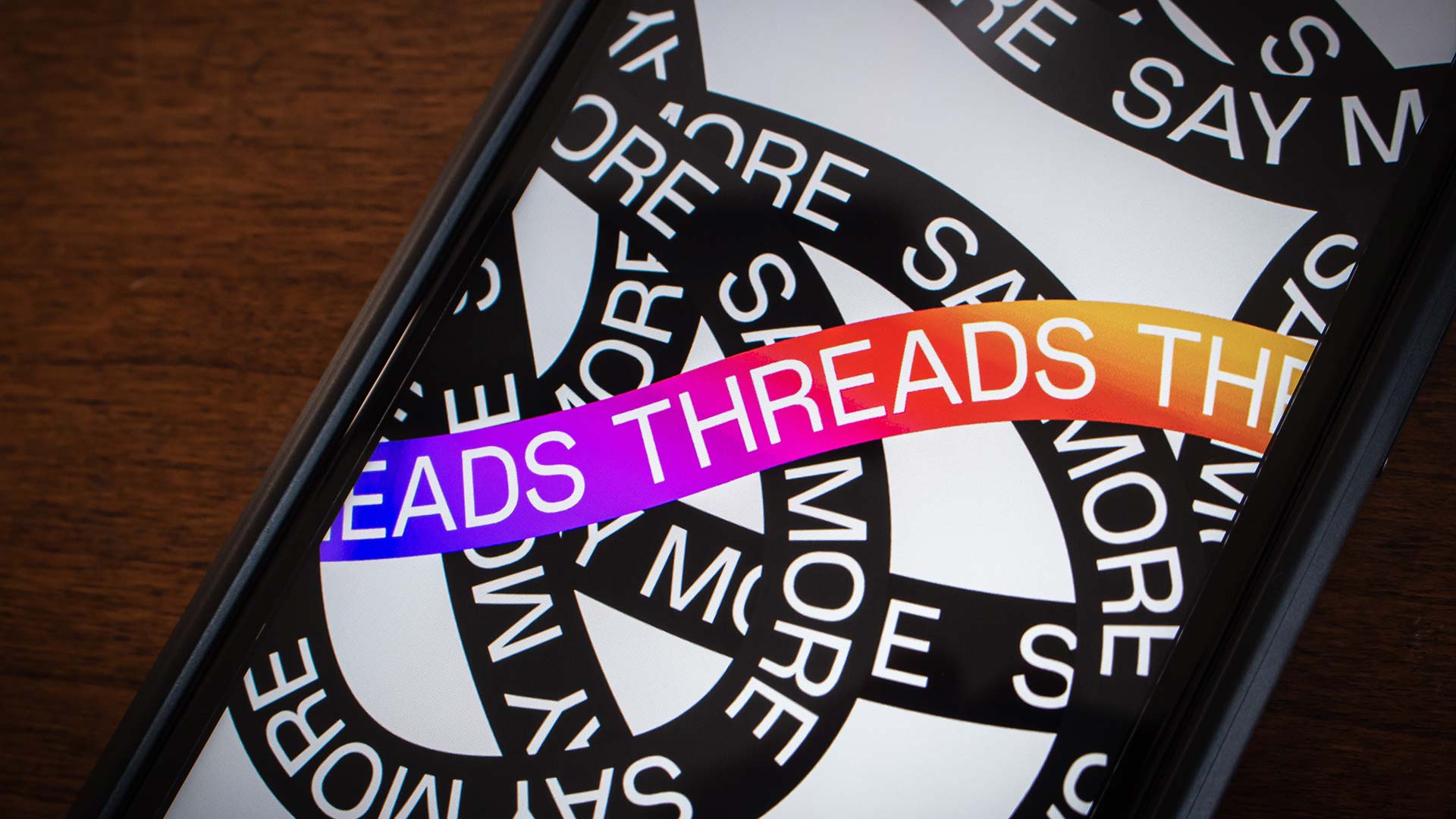 A smartphone displaying the Threads app interface, a social media platform. The post about about using Threads for growth